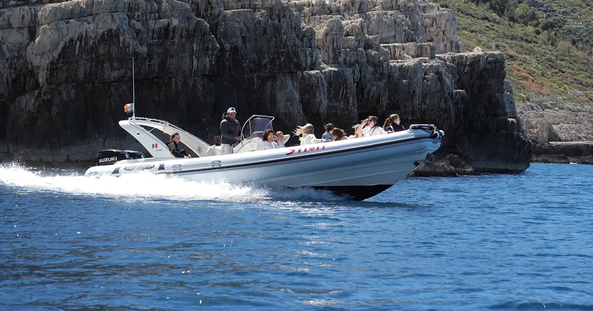 A high-speed boat tour operated by Vlora Boat Trip 3 Fiori, carrying travelers along the stunning cliffs of the Karaburun Peninsula in Vlora, Albania. This photo captures the excitement of the excursion as the boat cruises over clear blue water toward the region’s famous caves and bays.