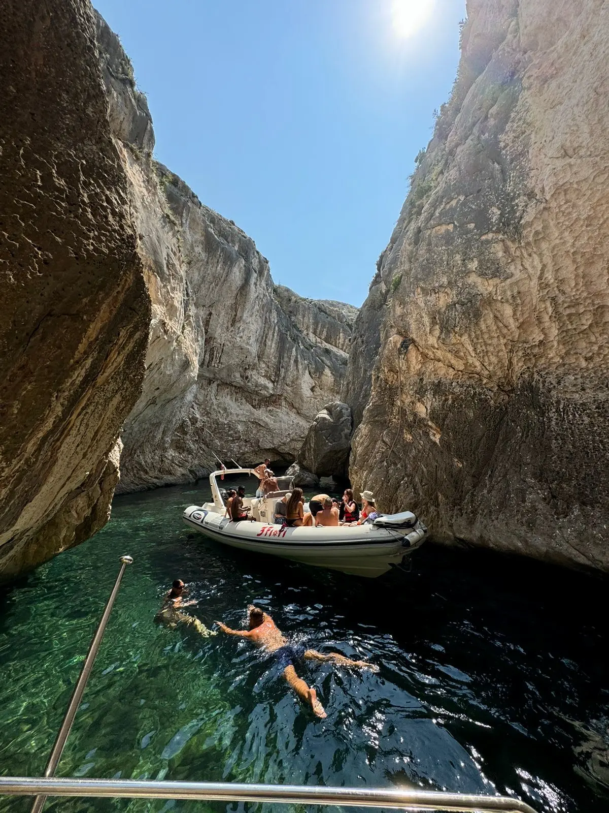 Guests swimming near a speedboat inside Canyon of Smugglers during a boat tour in Vlore, Albania.